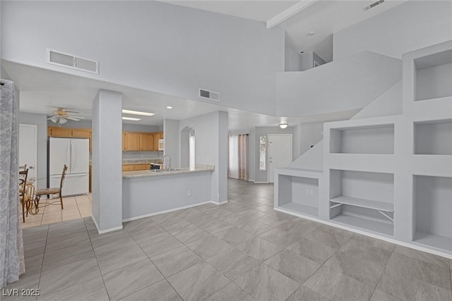 8005 Exploration Ave, Las Vegas, NV 89131 - unfurnished living room with baseboards, visible vents, built in features, and light tile patterned floors