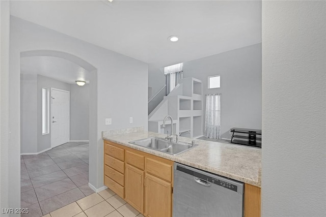 8005 Exploration Ave, Las Vegas, NV 89131 - kitchen with light countertops, arched walkways, a sink, dishwasher, and light tile patterned floors