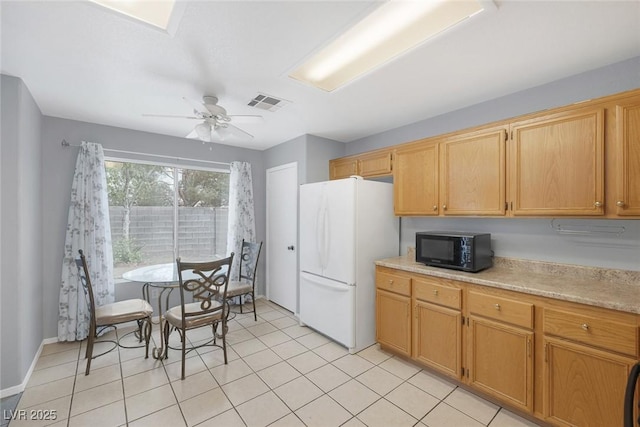 8005 Exploration Ave, Las Vegas, NV 89131 - kitchen with a ceiling fan, black microwave, light countertops, visible vents, and freestanding refrigerator