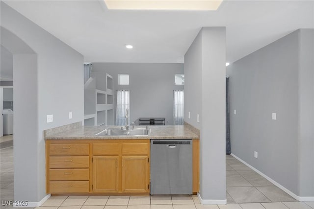 8005 Exploration Ave, Las Vegas, NV 89131 - kitchen featuring light countertops, dishwasher, light tile patterned floors, arched walkways, and a sink
