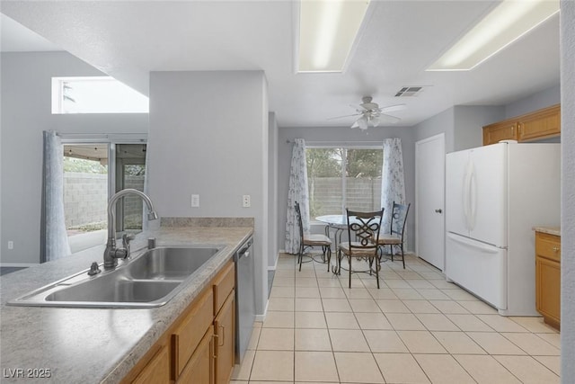 8005 Exploration Ave, Las Vegas, NV 89131 - kitchen featuring freestanding refrigerator, a wealth of natural light, stainless steel dishwasher, and a sink
