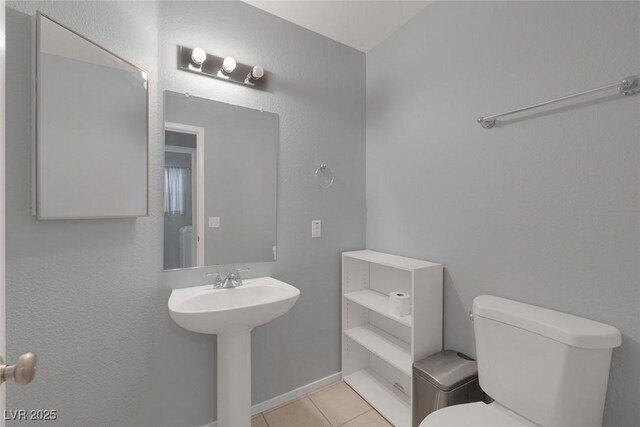 8005 Exploration Ave, Las Vegas, NV 89131 - half bathroom with a sink, toilet, tile patterned floors, and baseboards