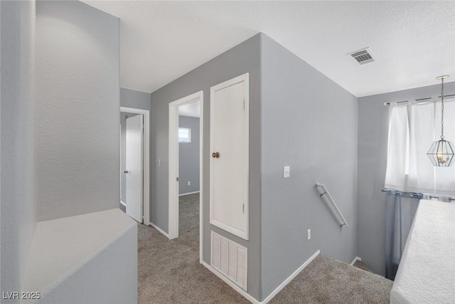 8005 Exploration Ave, Las Vegas, NV 89131 - hallway featuring carpet floors, an upstairs landing, visible vents, and baseboards