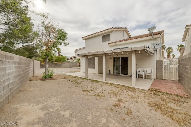 8005 Exploration Ave, Las Vegas, NV 89131 - rear view of house featuring a gate, a fenced backyard, a tiled roof, stucco siding, and a patio