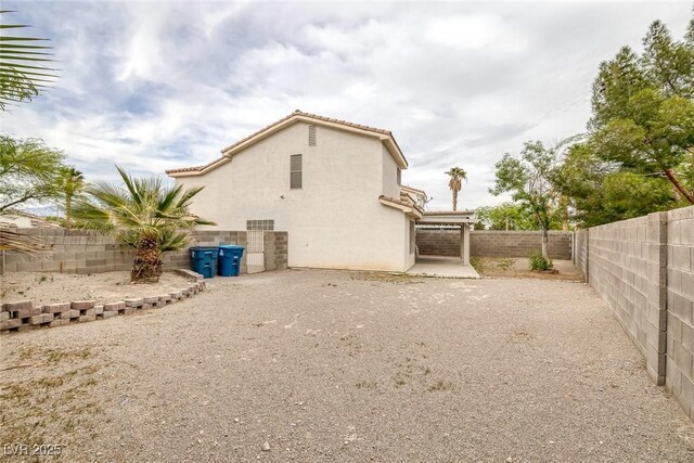 8005 Exploration Ave, Las Vegas, NV 89131 - back of property with a patio area, a fenced backyard, and stucco siding