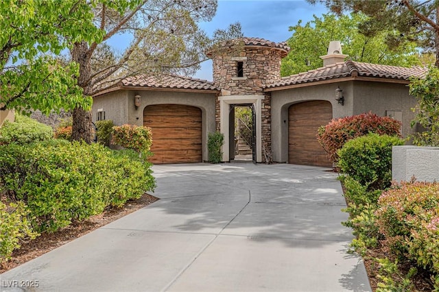 11814 Canons Brook Dr, Las Vegas, NV 89141 - mediterranean / spanish house featuring stucco siding, driveway, stone siding, a tile roof, and a garage
