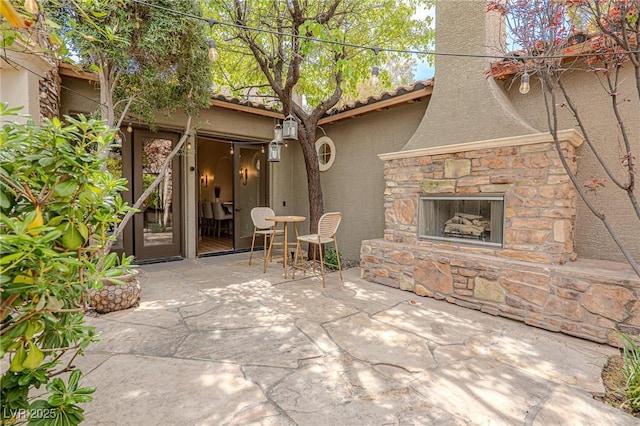 11814 Canons Brook Dr, Las Vegas, NV 89141 - view of patio featuring an outdoor stone fireplace