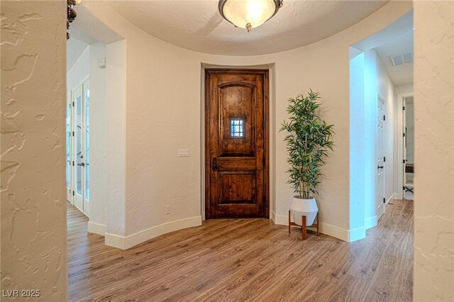 11814 Canons Brook Dr, Las Vegas, NV 89141 - entryway featuring baseboards, light wood finished floors, a textured wall, and visible vents