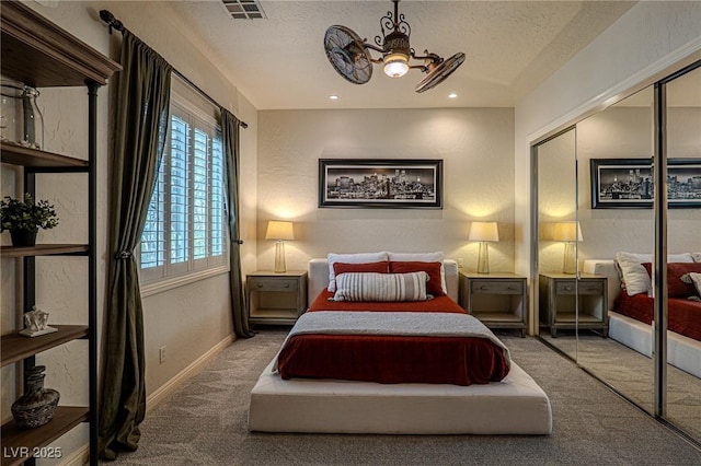 11814 Canons Brook Dr, Las Vegas, NV 89141 - carpeted bedroom featuring a textured ceiling, a closet, visible vents, baseboards, and a notable chandelier