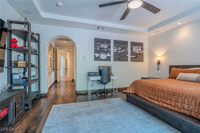 11814 Canons Brook Dr, Las Vegas, NV 89141 - bedroom featuring arched walkways, visible vents, wood finished floors, and a raised ceiling