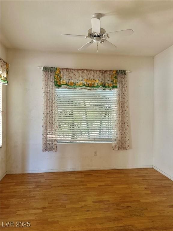 empty room with wood finished floors and ceiling fan