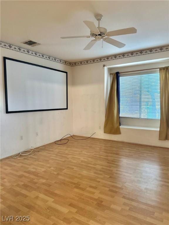 unfurnished room featuring visible vents, a ceiling fan, and light wood finished floors