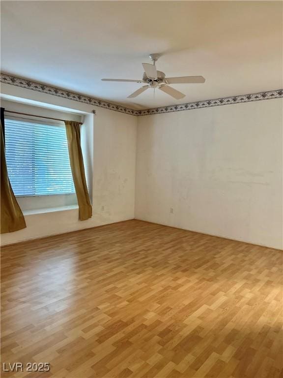 unfurnished room featuring light wood-style floors and ceiling fan