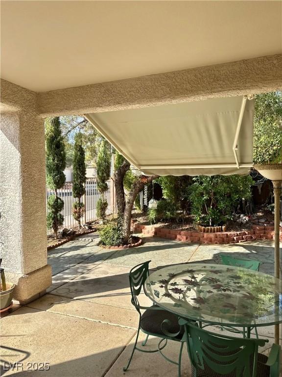 view of patio featuring fence