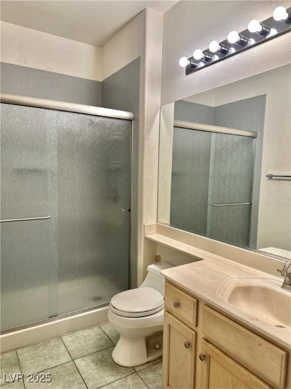bathroom with toilet, a stall shower, tile patterned flooring, and vanity