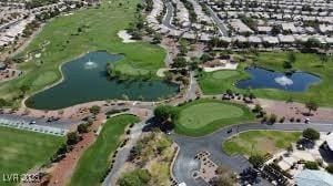 drone / aerial view featuring a residential view, a water view, and view of golf course