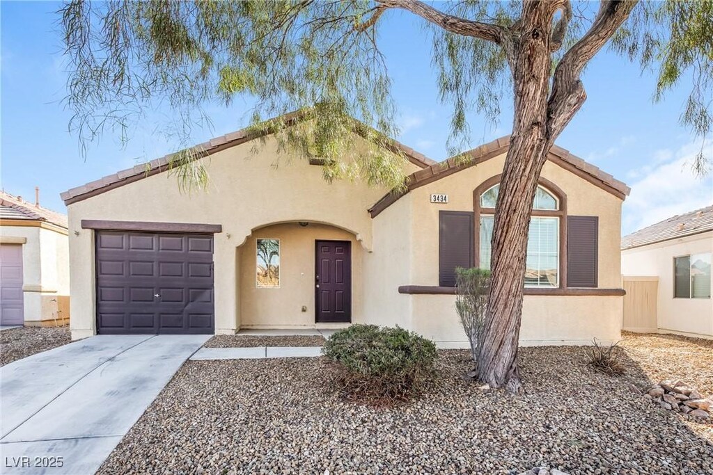 3434 Denali Preserve St, Las Vegas, NV 89122 - mediterranean / spanish house with an attached garage, driveway, and stucco siding