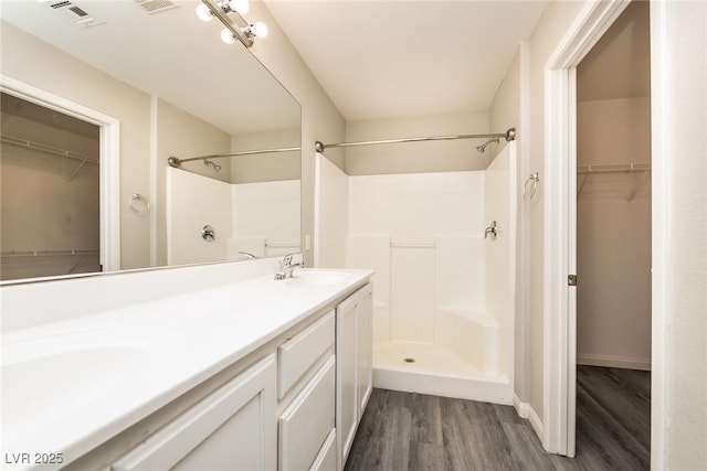3434 Denali Preserve St, Las Vegas, NV 89122 - full bath with a shower, a spacious closet, a sink, and wood finished floors