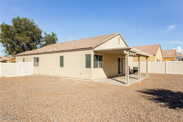 3434 Denali Preserve St, Las Vegas, NV 89122 - back of house with a pergola, a fenced backyard, stucco siding, a patio area, and a tile roof