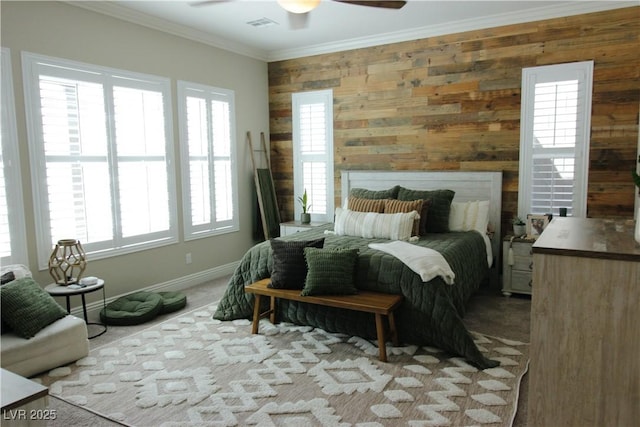 bedroom with crown molding, baseboards, multiple windows, and wooden walls