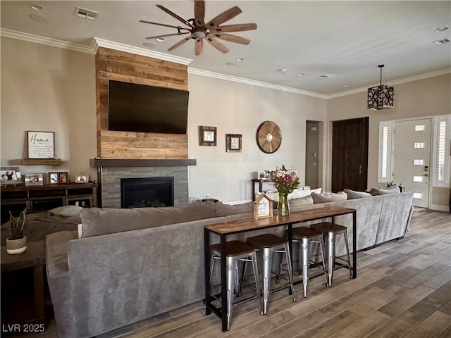 living room with recessed lighting, a fireplace, visible vents, ceiling fan, and wood finished floors