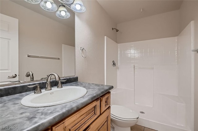 full bathroom with a shower, vanity, tile patterned flooring, and toilet