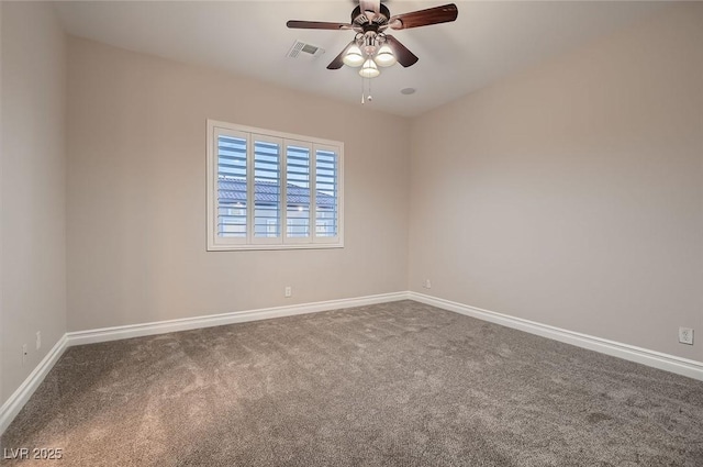 carpeted spare room with visible vents, baseboards, and ceiling fan