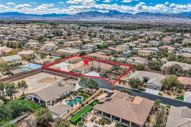 drone / aerial view featuring a residential view and a mountain view