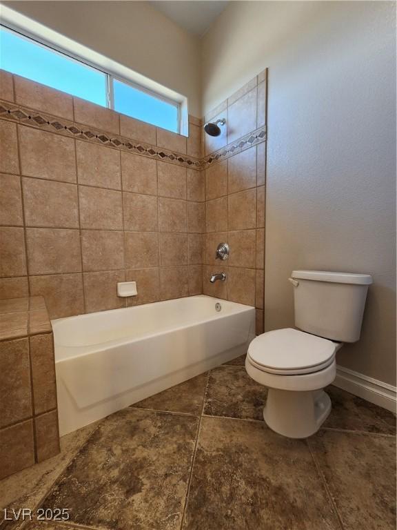 bathroom featuring toilet and bathing tub / shower combination