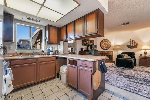 528 Close Ave, Henderson, NV 89011 - kitchen featuring visible vents, light tile patterned floors, a sink, open floor plan, and a peninsula