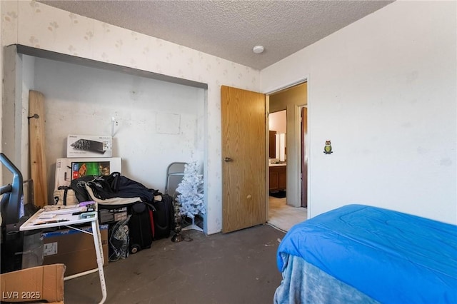 528 Close Ave, Henderson, NV 89011 - bedroom with concrete flooring, wallpapered walls, and a textured ceiling