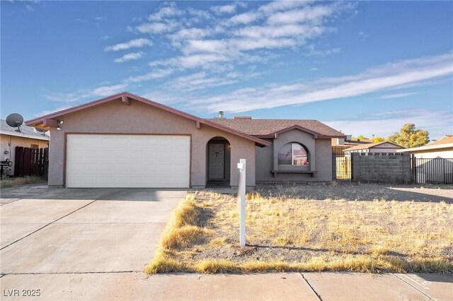 528 Close Ave, Henderson, NV 89011 - single story home with an attached garage, concrete driveway, stucco siding, and fence