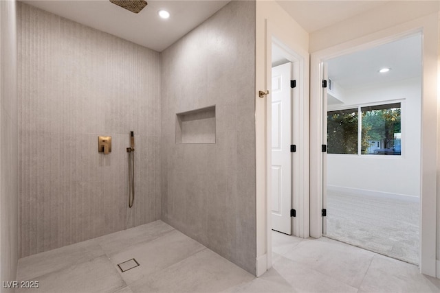 full bath with a tile shower, tile patterned flooring, and recessed lighting