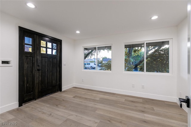 foyer entrance with baseboards, recessed lighting, and light wood finished floors