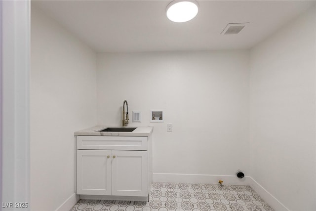 washroom with visible vents, washer hookup, a sink, and baseboards