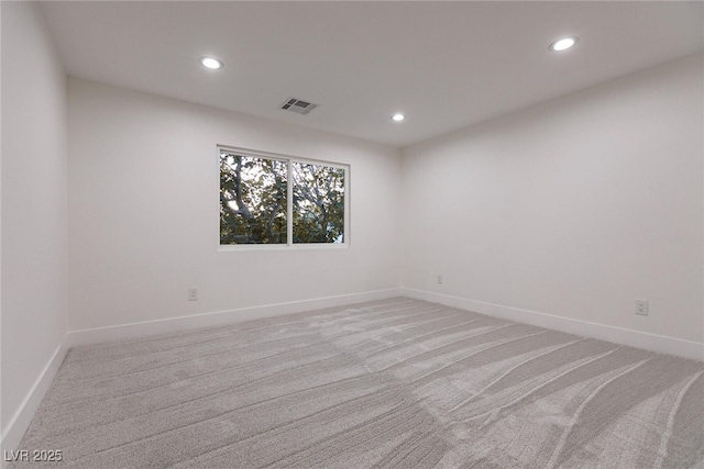 unfurnished room with light carpet, visible vents, and recessed lighting