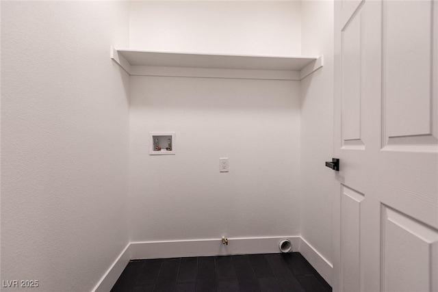 clothes washing area featuring gas dryer hookup, laundry area, baseboards, and hookup for a washing machine