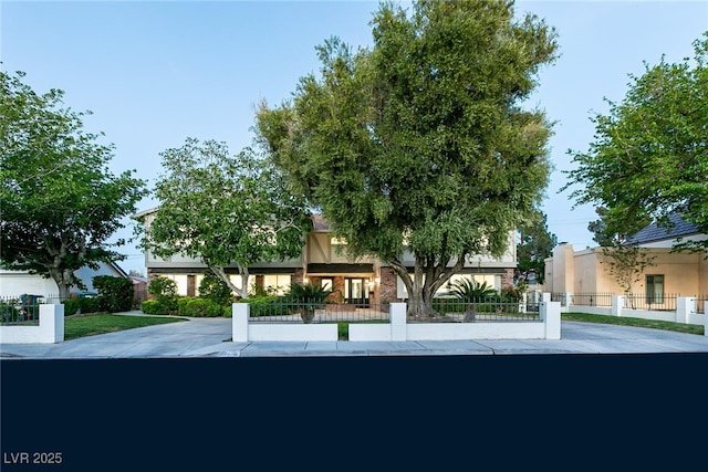 exterior space featuring stucco siding and a fenced front yard