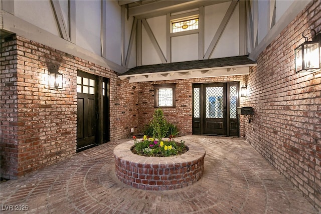 doorway to property featuring brick siding