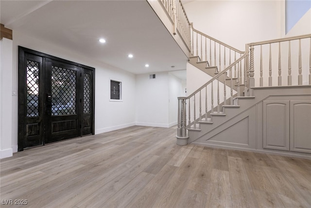 entryway with baseboards, recessed lighting, stairway, light wood-style flooring, and visible vents