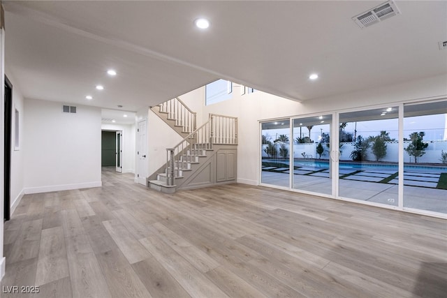unfurnished living room with light wood-type flooring, visible vents, and recessed lighting