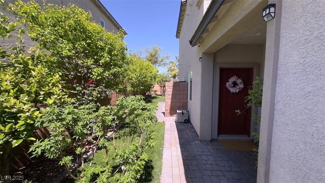 view of property exterior with stucco siding and fence