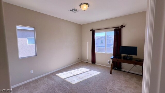 unfurnished office with carpet flooring and baseboards
