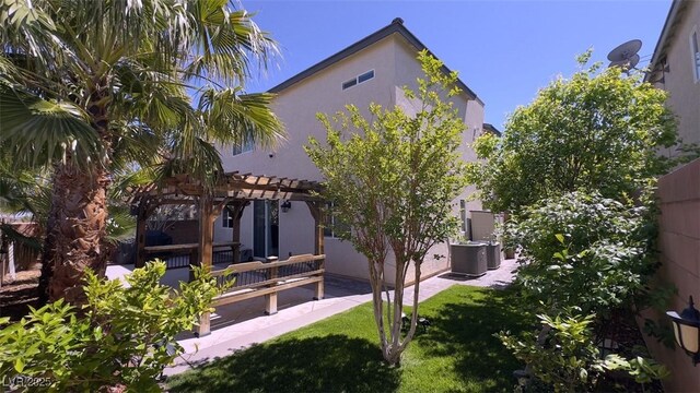 back of house featuring a pergola, stucco siding, a patio, and cooling unit