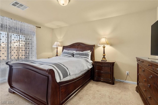 bedroom featuring visible vents, light colored carpet, and baseboards