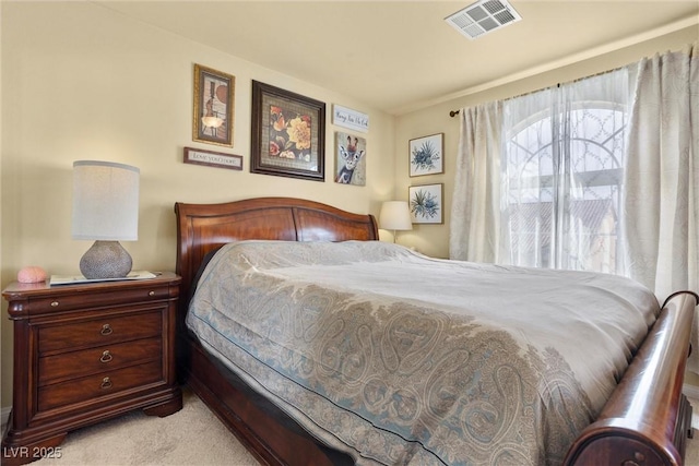 carpeted bedroom featuring visible vents