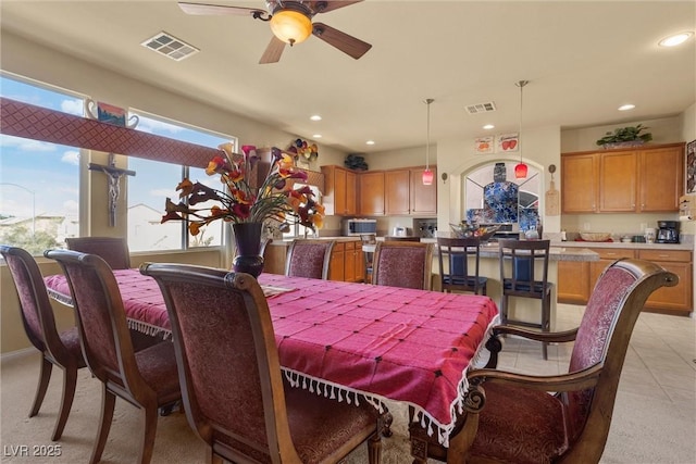 dining room with visible vents, a wealth of natural light, and ceiling fan