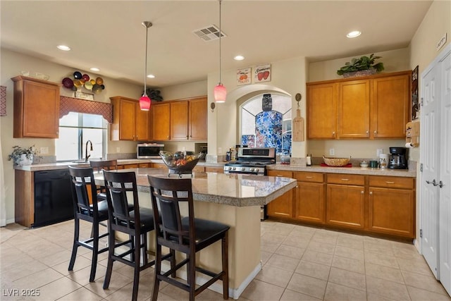 kitchen with visible vents, brown cabinets, and appliances with stainless steel finishes