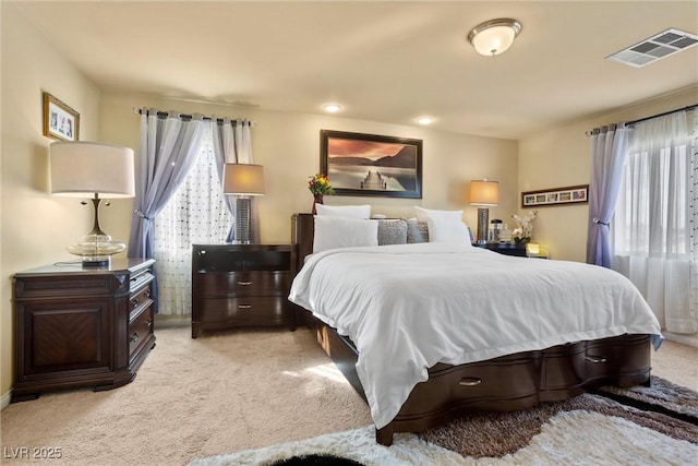 bedroom featuring visible vents, baseboards, and carpet