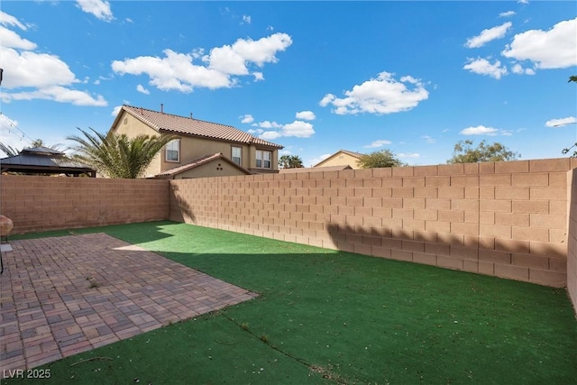 view of yard with a patio and a fenced backyard
